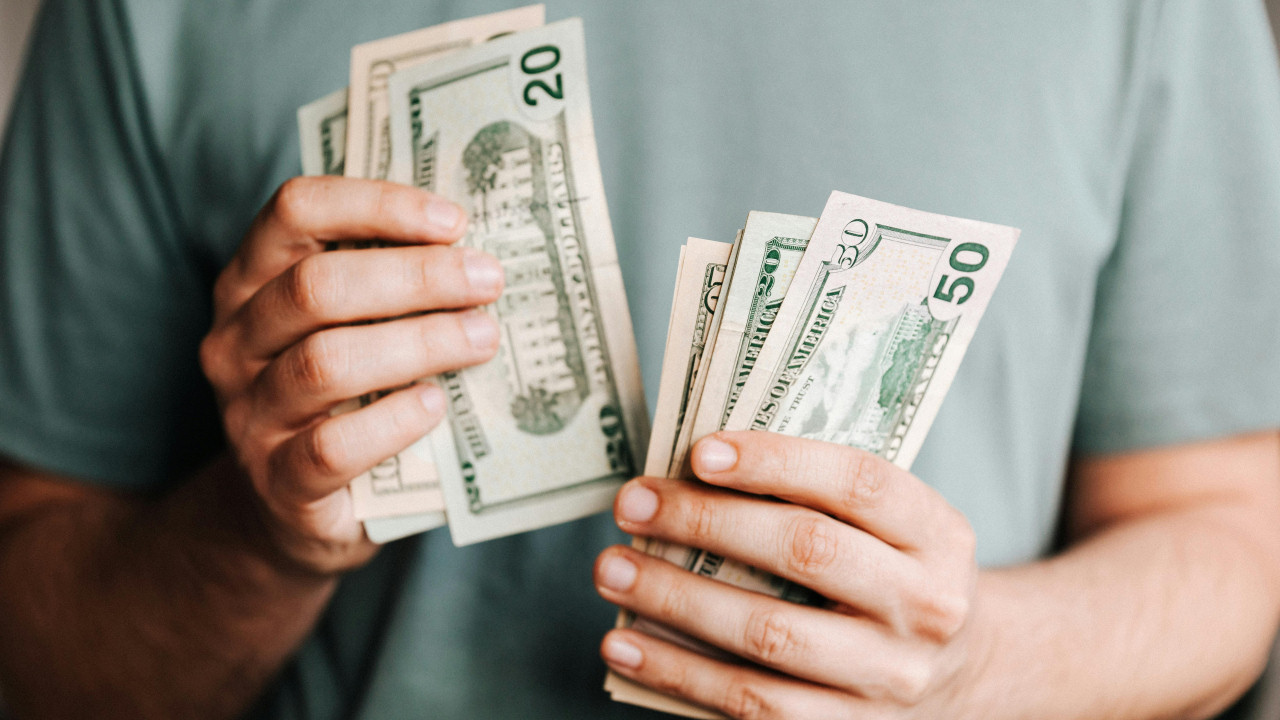 Photo By: Kaboompics.com: https://www.pexels.com/photo/crop-man-counting-dollar-banknotes-4386431/